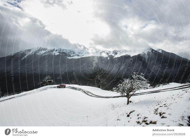 Red car driving in mountains Car Winter Mountain Drive Street Snow Vacation & Travel Cold Ice Weather Transport Landscape Frost Seasons Dangerous Freeze Vehicle