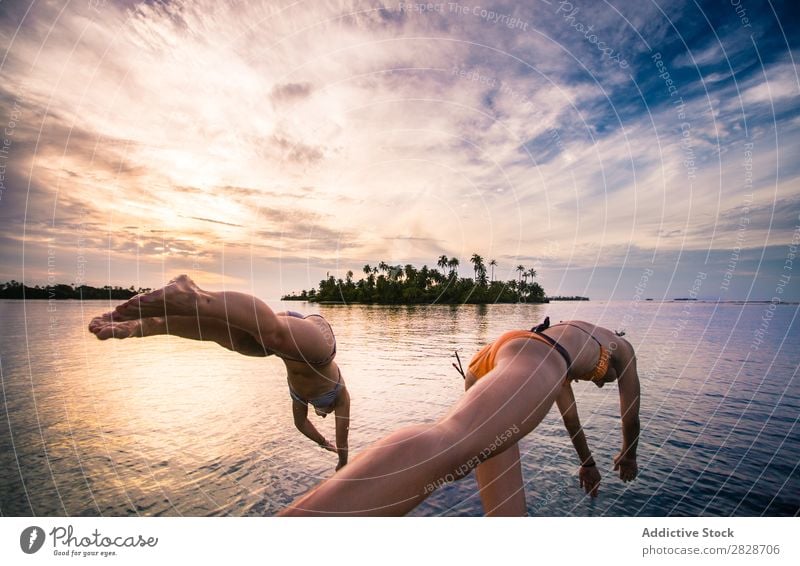 Women entering water of ocean Woman Ocean Jump Water Vacation & Travel in motion Summer Freedom Beach Leisure and hobbies Swimming Energy Action Healthy