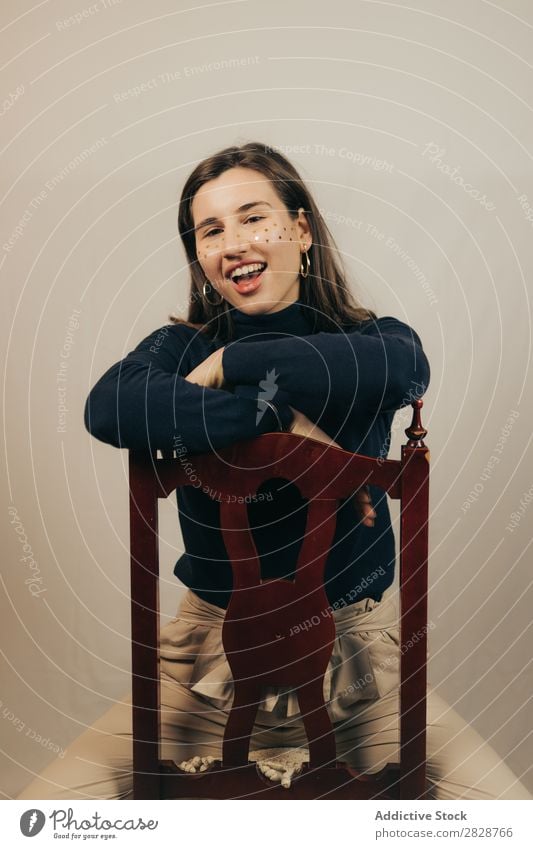 Smiling woman sitting on chair Woman pretty Youth (Young adults) Sit Beautiful Cheerful Chair glitters Face Brunette Attractive Human being Beauty Photography