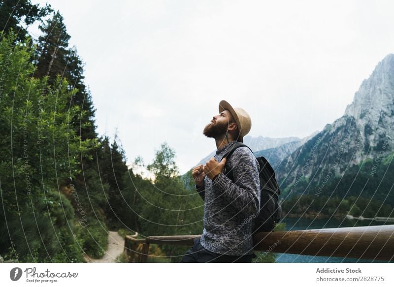 Handsome tourist at mountain lake Tourist Man Lake handsome bearded Nature Fence Wood Vacation & Travel Lifestyle Backpack Mountain Landscape Water