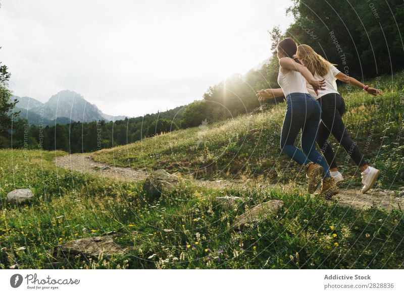 Cheerful women running on mountain road Woman Street Rural Friendship Backpack Nature Walking Girl Youth (Young adults) Beautiful Vacation & Travel Tourism Trip