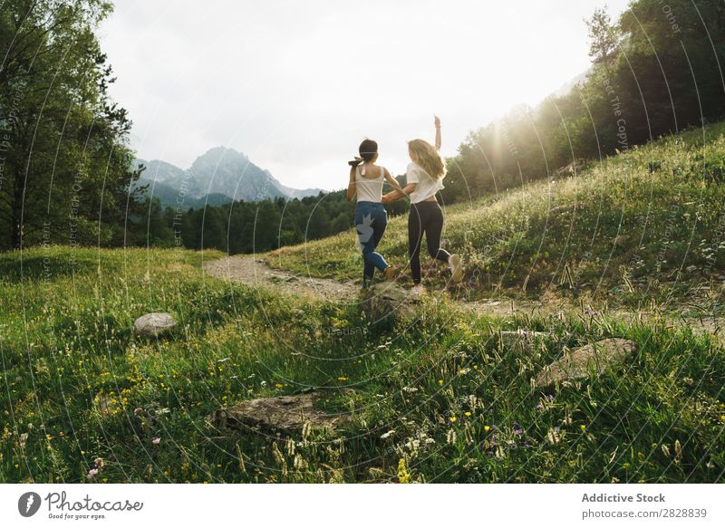 Cheerful women running on mountain road Woman Walking Street Rural Friendship Backpack Nature Girl Youth (Young adults) Beautiful Vacation & Travel Tourism Trip