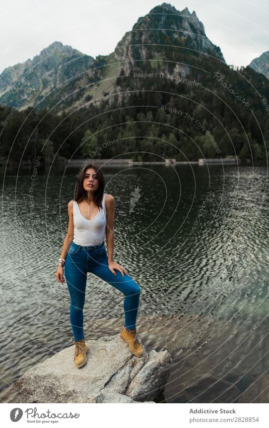 Woman standing on stone at lake Stone Lake Mountain Nature Landscape Water Rock Beautiful Youth (Young adults) Hiking Vacation & Travel Adventure Trip trekking