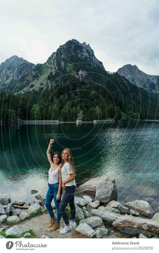 Women at lake in mountains Woman Mountain Walking Hiking Lake Water embracing Smiling Cheerful Happy Vacation & Travel Adventure Tourist Youth (Young adults)