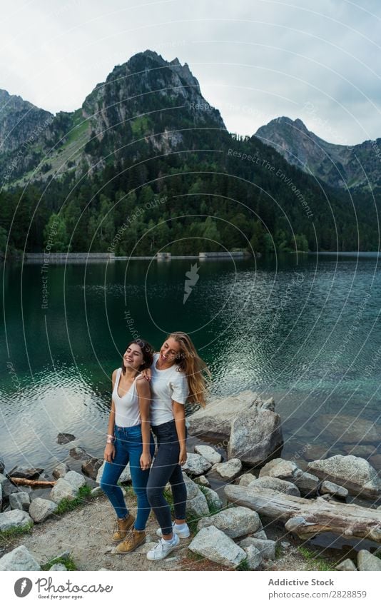 Women at lake in mountains Woman Mountain Walking Hiking Lake Water embracing Smiling Cheerful Happy Vacation & Travel Adventure Tourist Youth (Young adults)