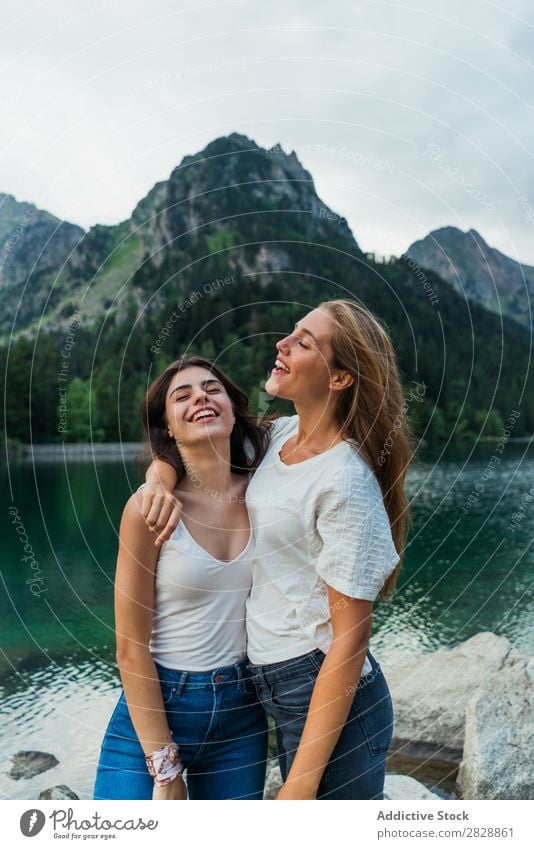 Women at lake in mountains Woman Mountain Walking Hiking Lake Water embracing Smiling Cheerful Happy Vacation & Travel Adventure Tourist Youth (Young adults)