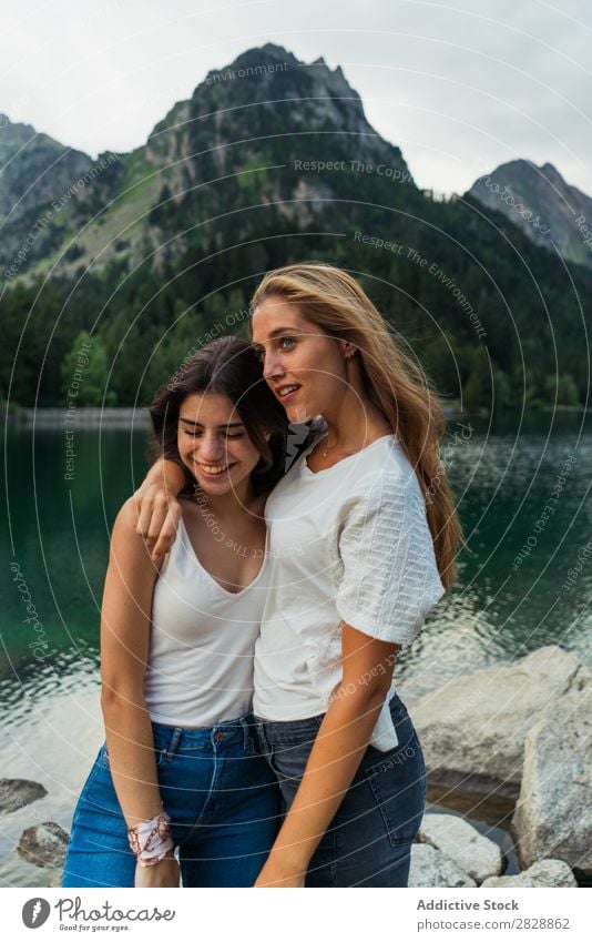 Women at lake in mountains Woman Mountain Walking Hiking Lake Water embracing Smiling Cheerful Happy Vacation & Travel Adventure Tourist Youth (Young adults)