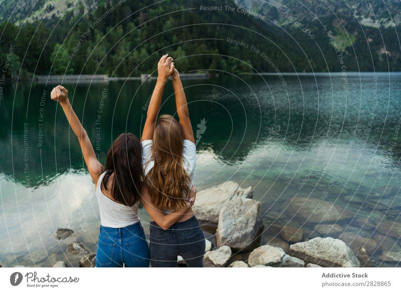 Women at lake in mountains Woman Mountain Walking Hiking Lake Water embracing Smiling Cheerful Happy Vacation & Travel Adventure Tourist Youth (Young adults)