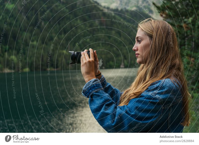 Woman taking shots on mountain lake Photographer Lake Mountain Camera Nature Landscape Water Beautiful Youth (Young adults) Hiking Vacation & Travel Adventure