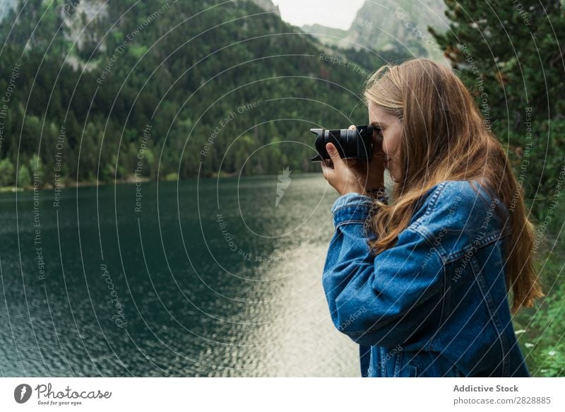 Woman taking shots on mountain lake Photographer Lake Mountain Camera Nature Landscape Water Beautiful Youth (Young adults) Hiking Vacation & Travel Adventure