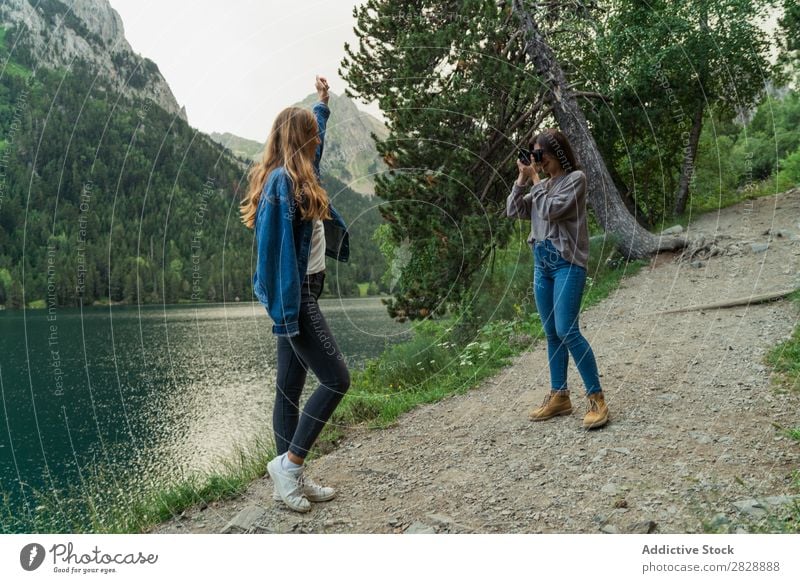 Women with camera in mountains Woman Mountain Walking Camera Photographer Posture Lake Water Take Together Smiling Hiking Cheerful Happy Vacation & Travel