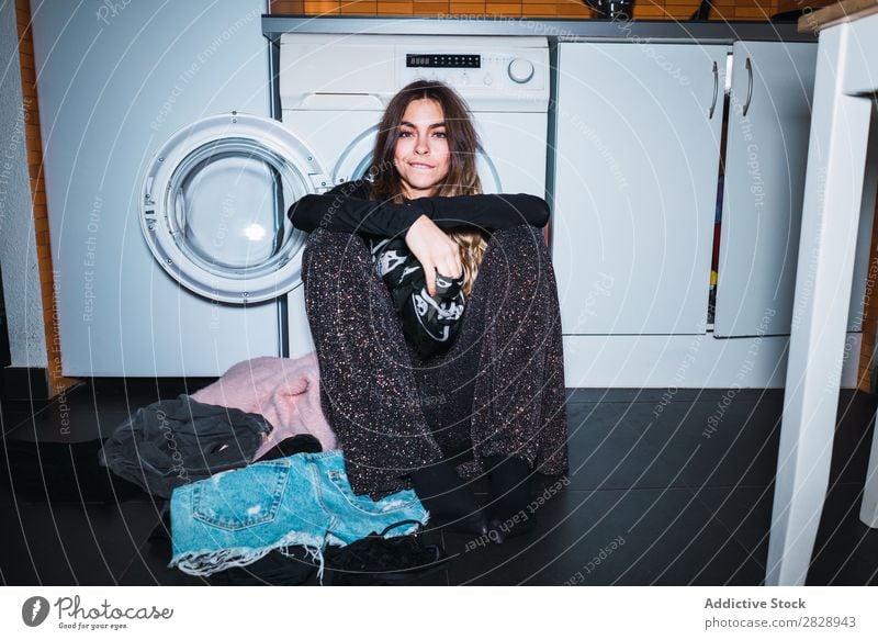 Woman sitting at laundry machine pretty Posture Home Laundry Clothing Sit Kitchen Smiling Beautiful Lifestyle Youth (Young adults) Human being Happy Attractive