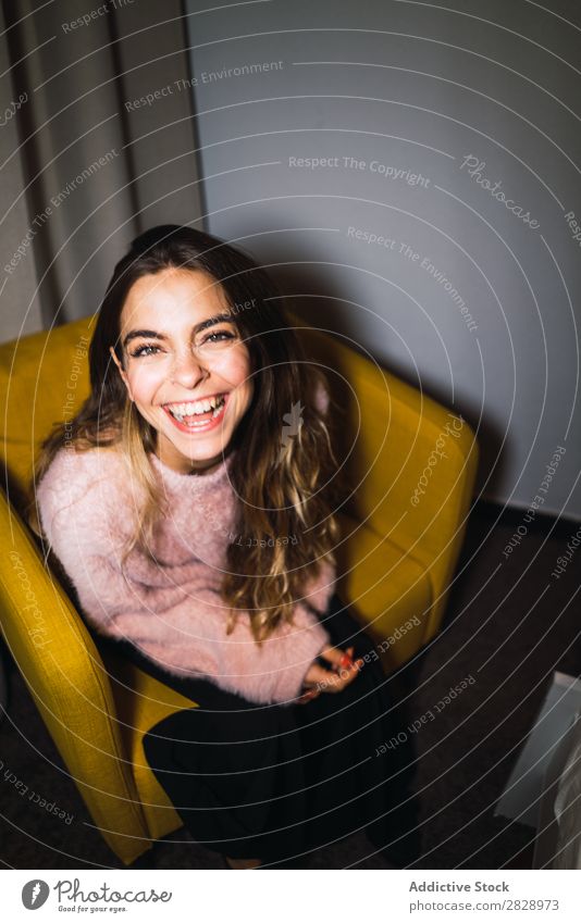 Young woman resting on armchair Woman Youth (Young adults) Attractive Home Sweater Pink Armchair Sit Happy Expressive Posture Alluring Beautiful Human being