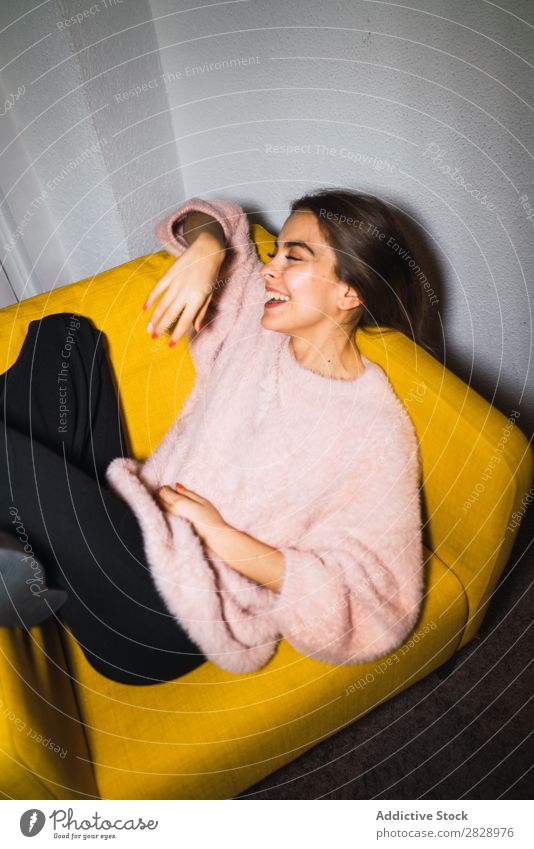 Young woman resting on armchair Woman Youth (Young adults) Attractive Home Sweater Pink Armchair Sit Lie (Untruth) Happy Expressive Posture Alluring Beautiful