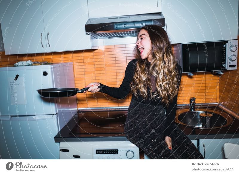 Woman sitting on kitchen table pretty Posture Home Sit Table Kitchen Beautiful Lifestyle Youth (Young adults) Human being Happy Attractive Portrait photograph