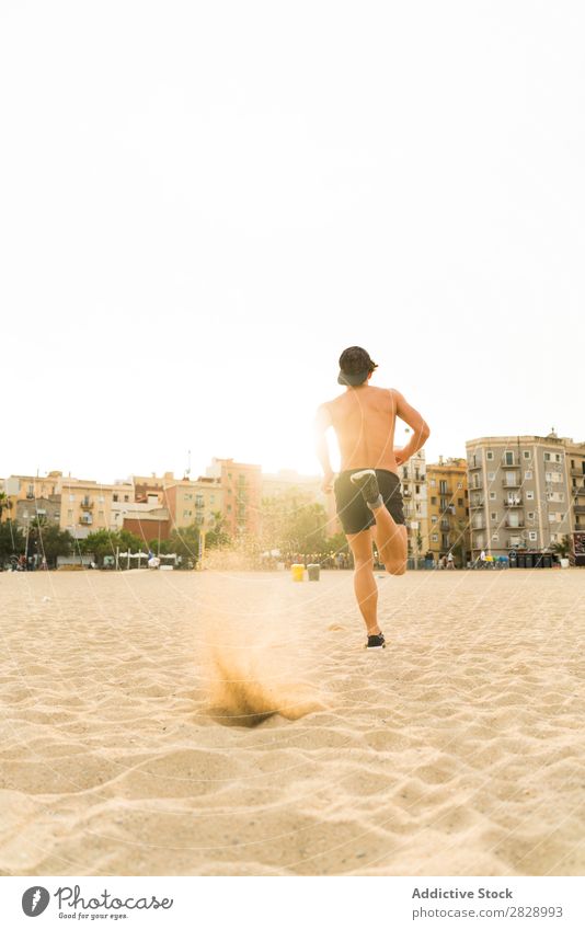 Man running in backlit Beach Athletic Running workout Action Jogging Fitness Runner Speed Exterior shot Movement Sportswear Healthy sprint Summer Town Energy