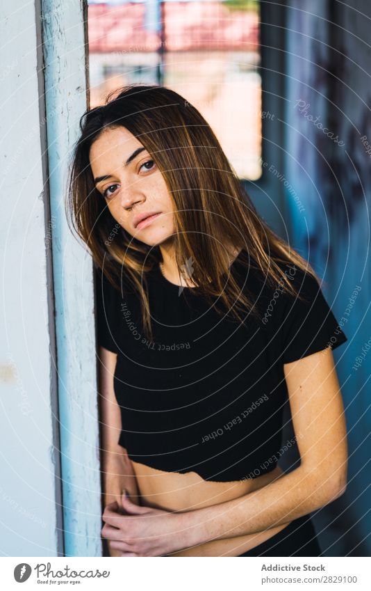 Woman posing in doorway abandoned Building Stand Lean pretty Looking into the camera Dream Pensive Considerate To enjoy Attractive Easygoing Relaxation