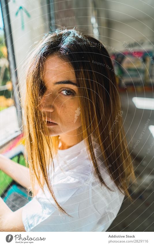 Smiling woman in abandoned room with graffiti Woman Cheerful Posture Looking into the camera Happy Youth (Young adults) grungy Graffiti Multicoloured Room