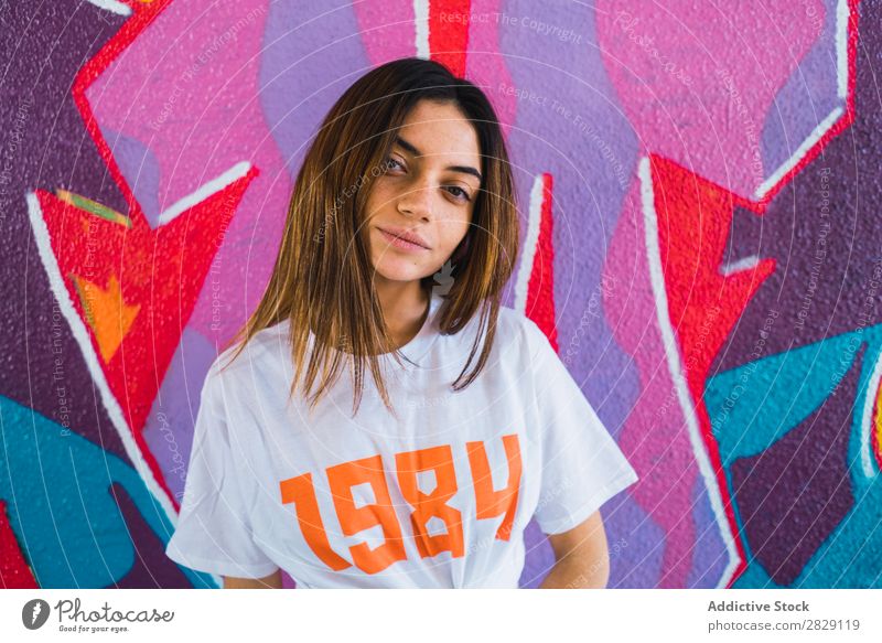 Smiling woman in abandoned room with graffiti Woman Cheerful Posture Looking into the camera Happy Youth (Young adults) grungy Graffiti Multicoloured Room