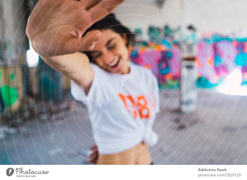 Smiling woman in abandoned room with graffiti Woman Cheerful Posture Happy Youth (Young adults) grungy Graffiti Multicoloured Room pretty Easygoing Building