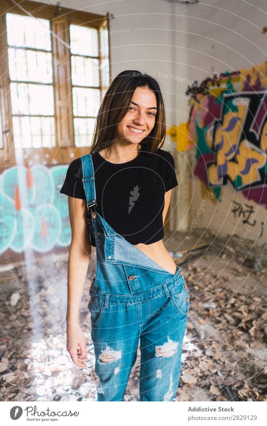 Woman posing in abandoned building Building Smiling Cheerful Posture Graffiti Attractive To enjoy Hair Set Youth (Young adults) Portrait photograph Beautiful