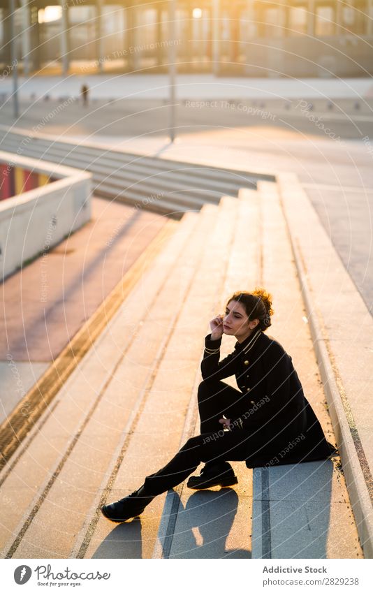 Attractive woman on stairs Woman Stairs Sit Looking away Easygoing Clothing Self-confident Style Earnest Youth (Young adults) Hair Beautiful Girl glamour Lady