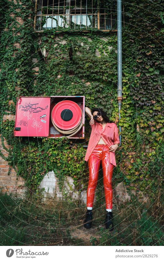 Woman posing at fire hose Style Street Town Fire-fighting tube Red Posture Plant Growth Sunglasses Portrait photograph Attractive Beauty Photography