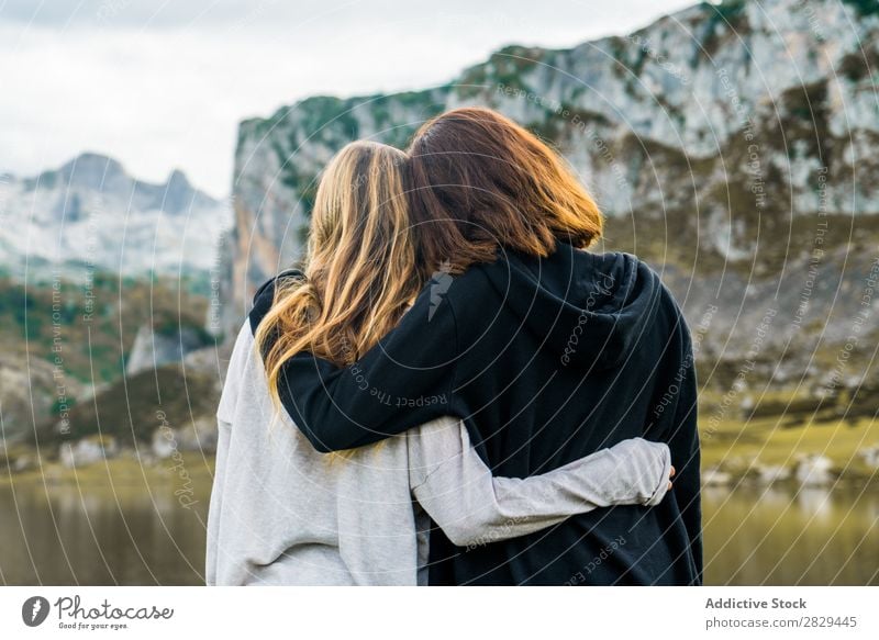 Women standing at lake Woman Meadow Lake embracing Stand Together Friendship Relaxation Mountain Nature Field Girl Grass Beautiful Youth (Young adults) Green