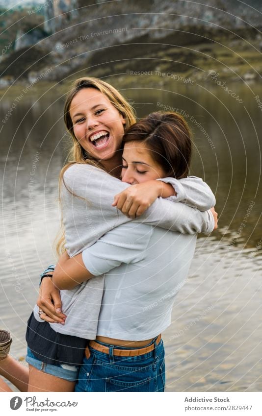 Girls hugging at lake Woman Meadow Lake embracing Stand Together Friendship Relaxation Mountain Nature Field Grass Beautiful Youth (Young adults) Green Spring