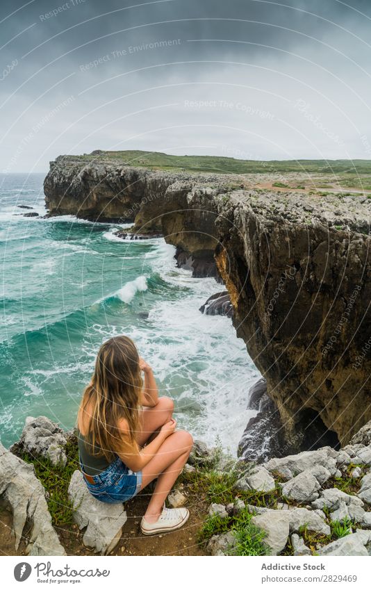 Woman sitting on cliff Cliff Ocean Sit Beautiful Rock Summer Nature Vacation & Travel Water Landscape Youth (Young adults) Blue Lifestyle Freedom Hiking Top