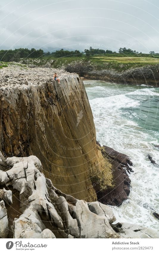 Woman sitting on cliff edge Cliff Sit Beautiful Rock Summer Nature Vacation & Travel Water Landscape Youth (Young adults) Blue Lifestyle Ocean Freedom Hiking