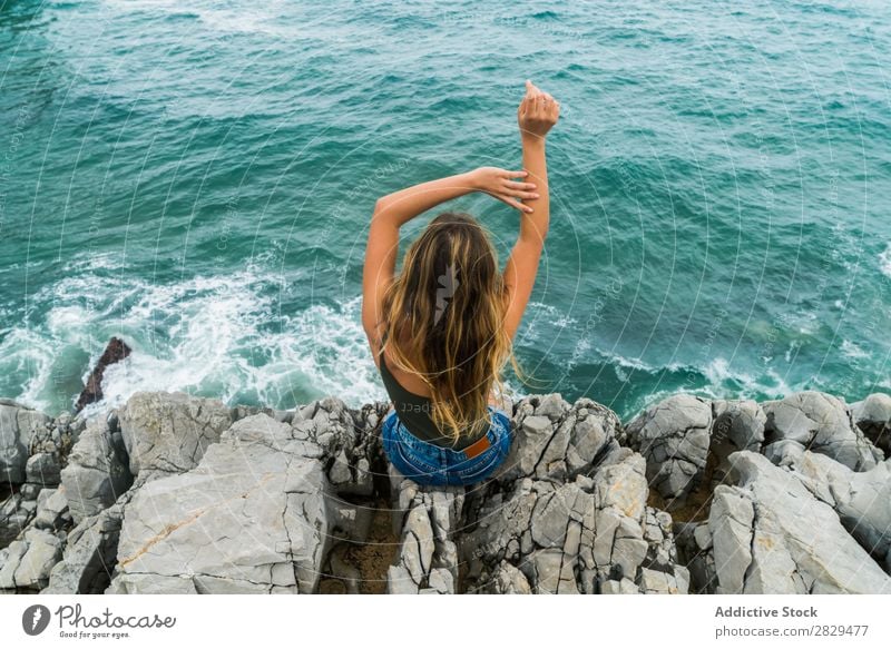 Woman sitting at edge of rock Cliff Ocean Sit Beautiful Rock Summer Nature Vacation & Travel Water Landscape Youth (Young adults) Blue Lifestyle Freedom Hiking