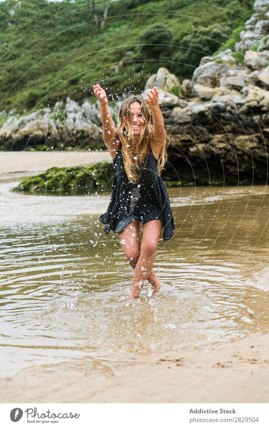 Cheerful girl playing in water Woman Water Beach having fun Splashing Nature Happiness Vacation & Travel Summer Rock Tropical Playing Action Style Playful