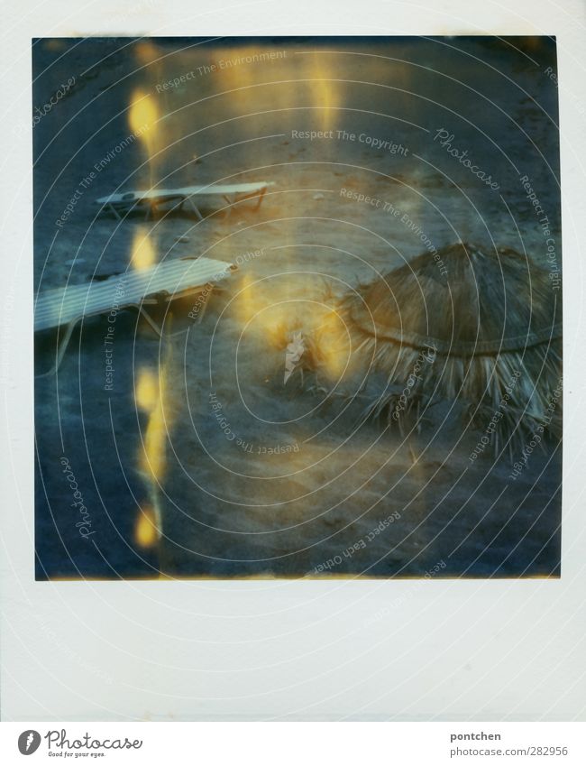 Polaroid. Beach chairs and parasol made of straw lie on sand. Deserted beach. Vacation lonely Couch Deckchair Sunshade Broken Sand Light (Natural Phenomenon)