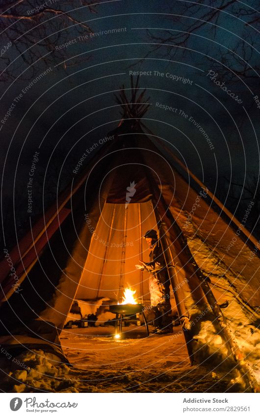 Man warming in tent Winter Nature Cold North Covered Tent Light Night Bonfire Human being Stand Tourist traveller Forest Snow Seasons White Landscape Ice Frost