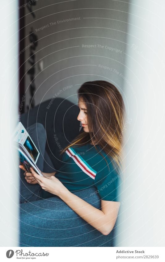 Girl reading magazine behind window Woman chill Magazine Flat (apartment) through glass Contentment pose Idyll Posture Relaxation Interior design enjoyment