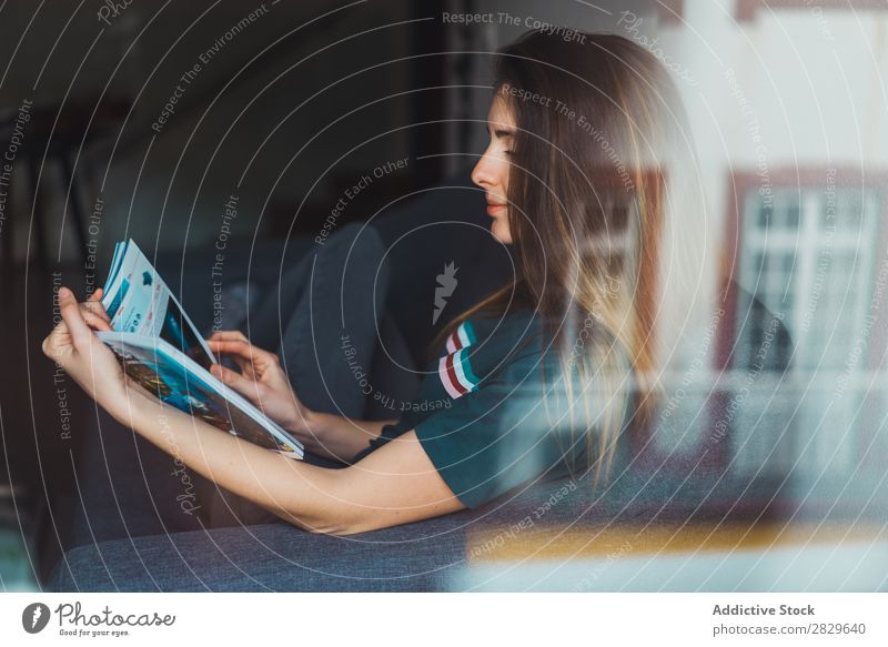 Girl reading magazine behind window Woman chill Magazine Flat (apartment) through glass Contentment pose Idyll Posture Relaxation Interior design enjoyment