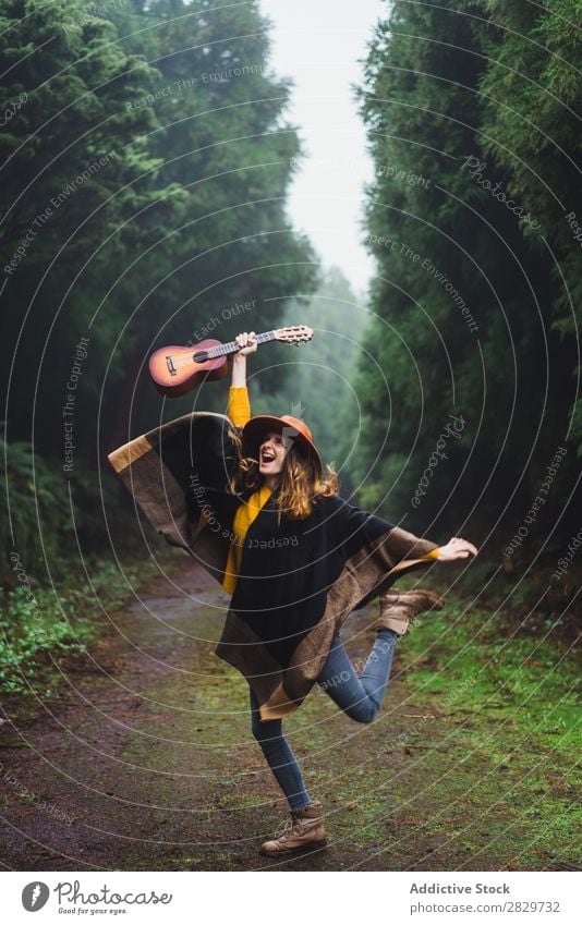 Jumping woman with ukulele in woods Woman Forest Happiness Freedom Fog Ukulele traveler Expression Excitement Movement romantic Energy Trip Cold above ground