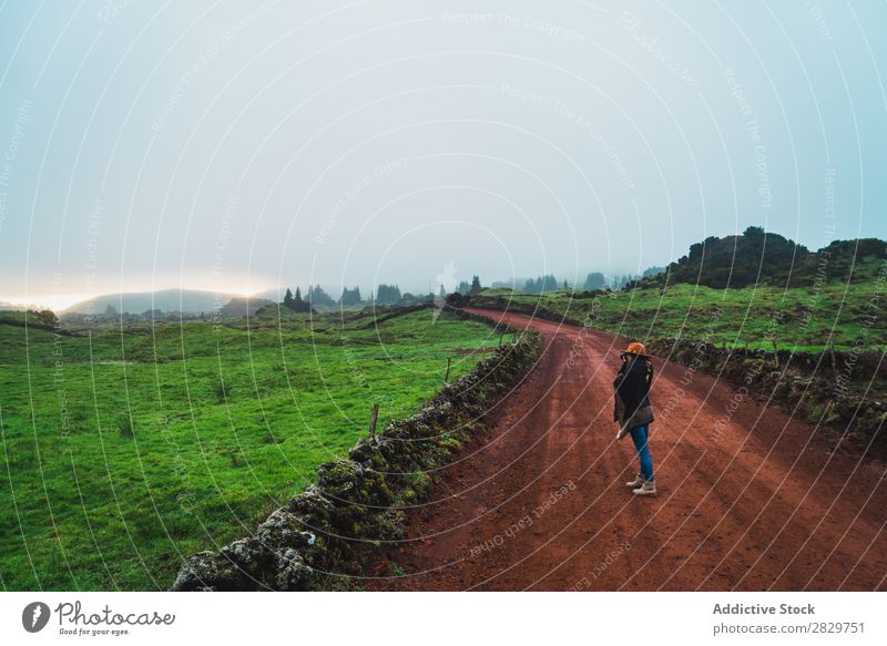 Woman on rural green road Nature Rural Landscape Street Fog Cold Lanes & trails pathway Countries Dream Calm Stand Tourism tranquil Pensive Vacation & Travel