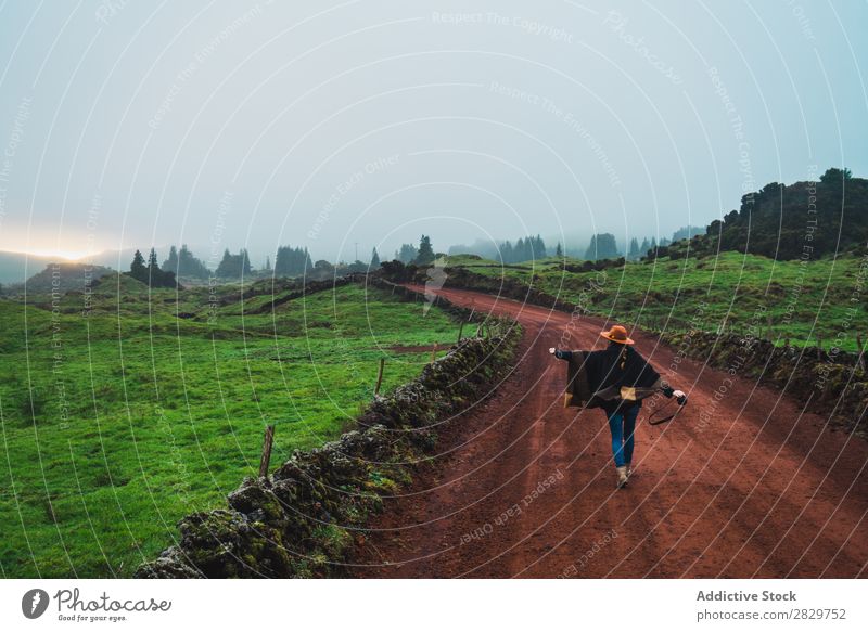 Woman on rural green road Nature Rural Landscape Street Fog Cold Lanes & trails pathway Countries Dream Calm Stand Tourism tranquil Pensive Vacation & Travel