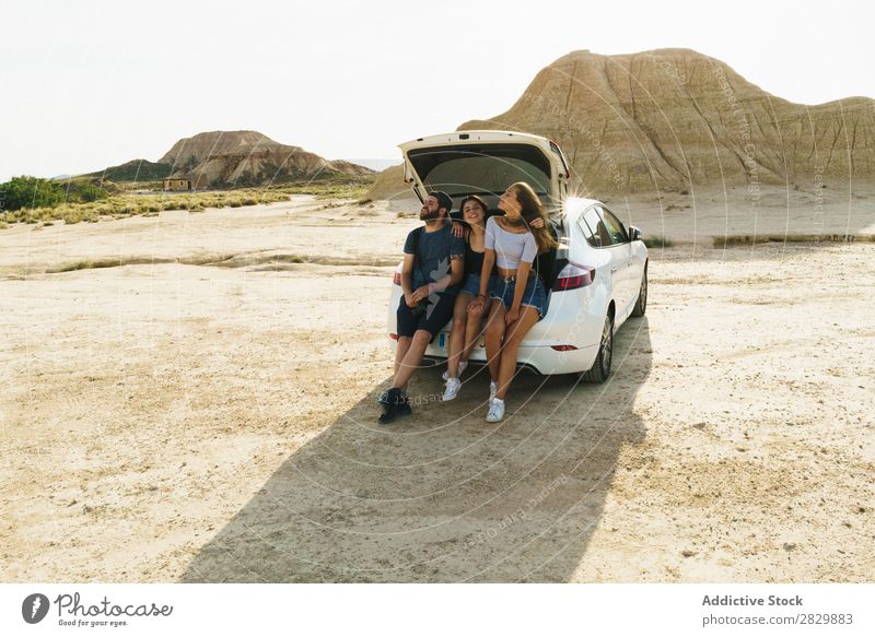 Friends sitting in car trunk Friendship Trunk Together Summer Human being Trip Joy Vacation & Travel Happy Adventure Lifestyle Youth (Young adults) Street