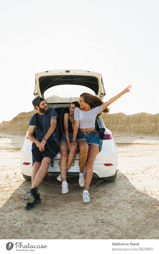 Friends sitting in car trunk Friendship Trunk Together Summer Human being Trip Joy Vacation & Travel Happy Adventure Lifestyle Youth (Young adults) Street