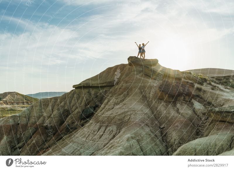 Women posing on cliff Woman Cliff Excitement Stand Hands up! Freedom Vacation & Travel Success Top Mountain Youth (Young adults) Nature Rock Landscape Happy