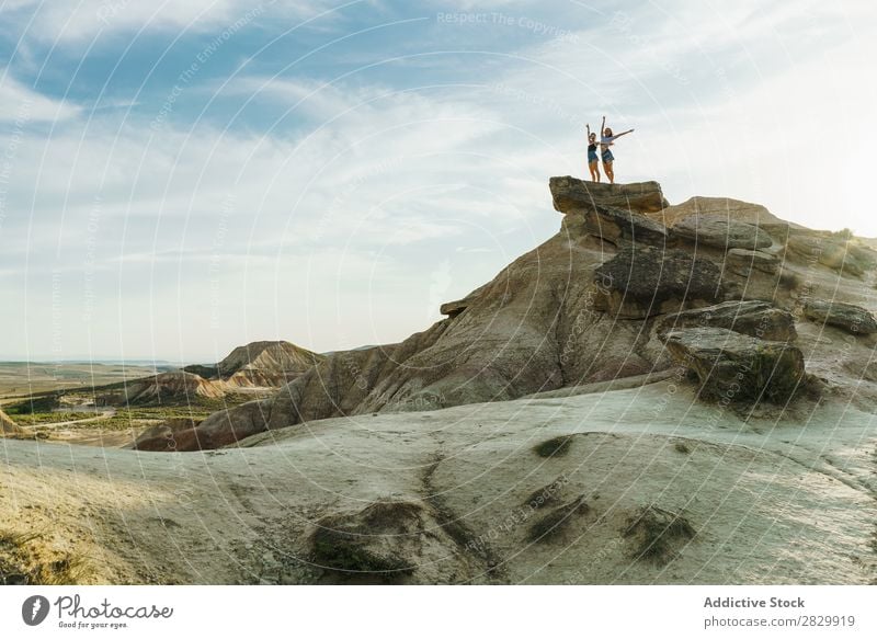 Women posing on cliff Woman Cliff Excitement Stand Hands up! Freedom Vacation & Travel Success Top Mountain Youth (Young adults) Nature Rock Landscape Happy