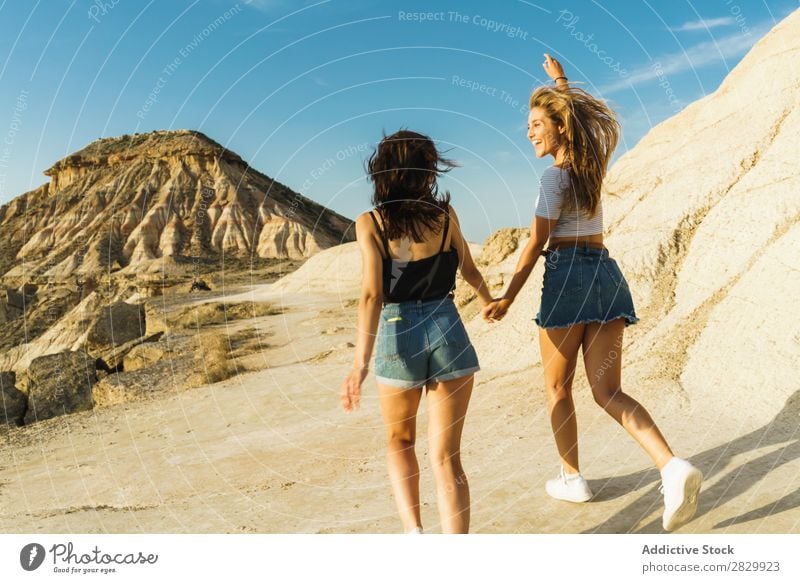 Happy women walking on hill Woman Cliff Excitement Running holding hands Freedom Vacation & Travel Success Top Mountain Youth (Young adults) Nature Rock