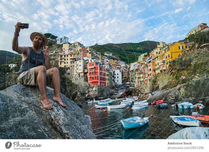 Man taking selfie on coastal city Rock traveler Skyline PDA Bay Tourist Nature Cliff Posture Watercraft Connection browsing Tourism using Coast Internet