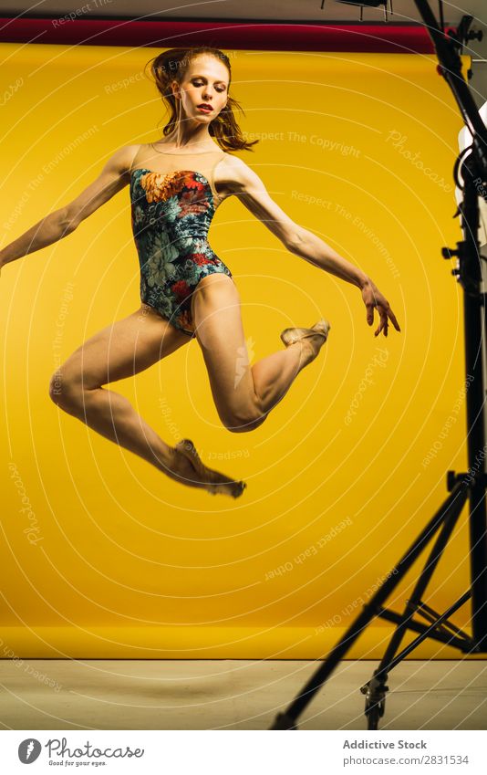 Woman jumping in studio pretty Portrait photograph Youth (Young adults) Jump Ballet Dance Beautiful Adults Posture Smiling Beauty Photography Attractive Model