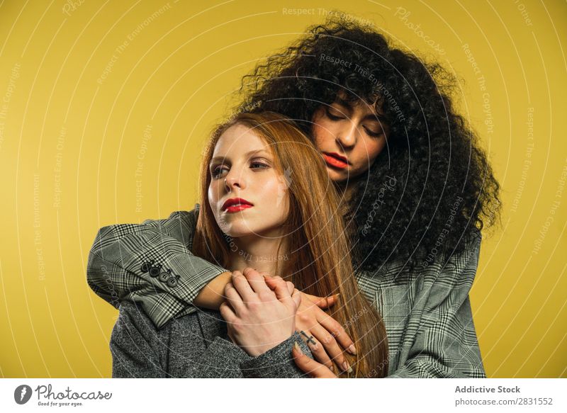 Two women embracing in studio Woman pretty Portrait photograph Couple Homosexual Curly Brunette Alternative lgbt Youth (Young adults) Beautiful Adults Posture