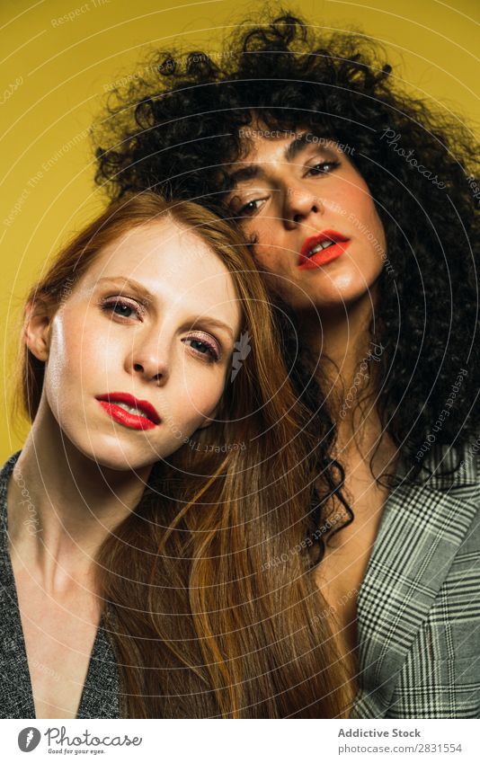 Two women embracing in studio Woman pretty Portrait photograph Couple Homosexual Curly Brunette Alternative lgbt Youth (Young adults) Beautiful Adults Posture