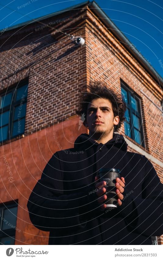 Young man with coffee on street Man handsome City Street Coffee Warmth Looking away Drinking Beverage Paper cup Youth (Young adults) Town Lifestyle Easygoing